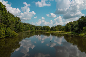 Fototapeta na wymiar Sky reflected in the river in the woods