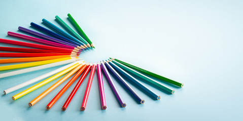 Fototapeta premium Colour pencils set on light blue background