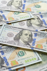 Background from chaotically lying of notes for one hundred dollars.