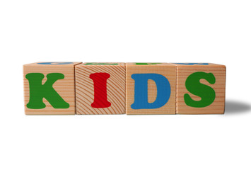 Wooden alphabet toy blocks with the text: Kids. Isolated kids ABC cubes on white background with copy space for your design.