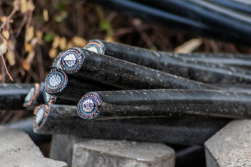 Dicke schwarze Stromkabel zeigen einen bei Bauarbeiten verursachten Leitungsschaden mit Verbindungsstörung