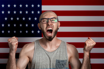 Emotions of anger and indignation. The man in glasses clenched his hands into fists and shouted. In...