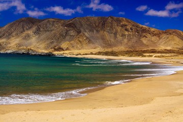 View on deserted secluded beach in dry harsh bare surrounding at pacific coastline in Chile