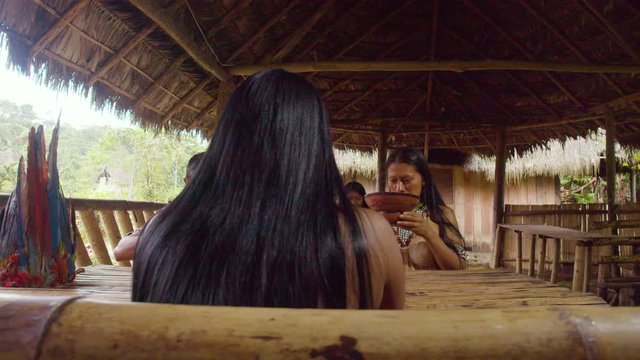 Amazonian Indigenous People Drinking Fermented Yucca Beverage Chicha In Ecuador