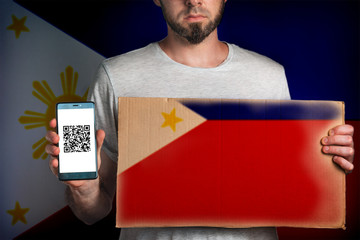 Concept of freedoms and human rights. A man with a cardboard and a phone in his hand. The Flag of...