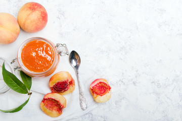 Homemade peach jam with organic fruit. Sweet preserves on a light background, , copy space