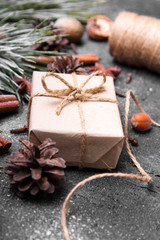  Christmas presents, pine twigs and cones covered with snow on dark background