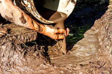 Boy working and playing in the mud