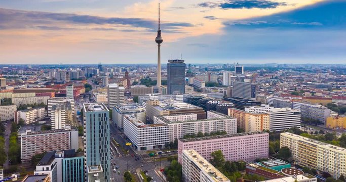 Aerial view of Berlin skyline with famous TV tower at Alexanderplatz and dramatic clouds in twilight during blue hour at dusk, Germany