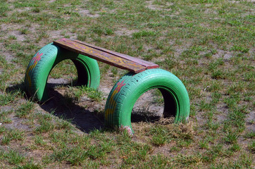 Painted car tires for kindergarten playground equipment.Modern ghetto. Bad district. Residential...