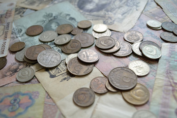 coins on the background of paper money