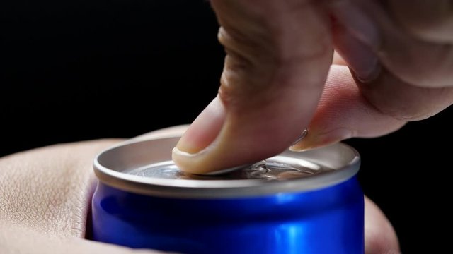 hand opening the can of energy drink, close-up