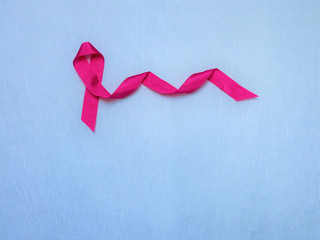 Woman wih pink ribbon on chest.  mature female  showing symbol representing awareness, hope and moral support for breast cancer
