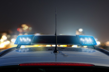 police car on the road at night