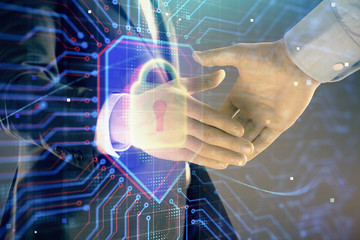Multi exposure of lock icon drawing on abstract background with two men handshake. Concept of data securitization