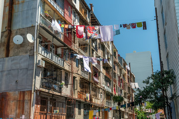 Colorful clothes drying in Georgia hangs down from the balconies. Traditional Georgian method of drying clothes on a sunny day