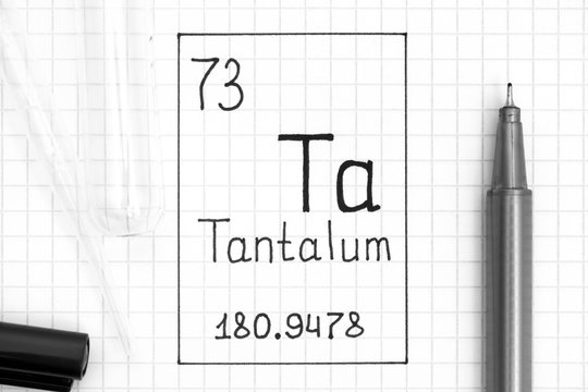 The Periodic table of elements. Handwriting chemical element Tantalum Ta with black pen, test tube and pipette.