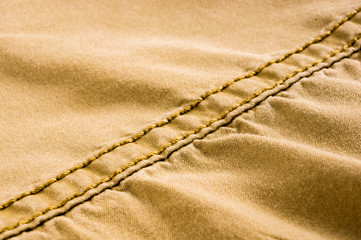 clothing items stonewashed cotton fabric texture with seams, clasps, buttons and rivets, macro