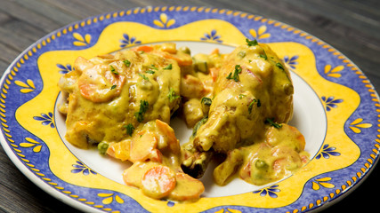 Chicken dish from a restaurant. Chicken with curry sauce.