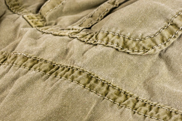 clothing items stonewashed cotton fabric texture with seams, clasps, buttons and rivets, macro