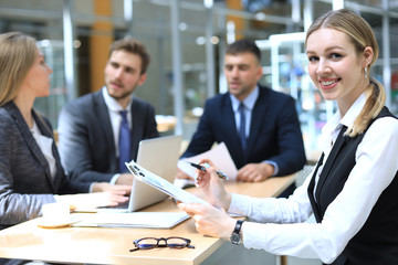 business woman with her staff, people group in background at modern bright office indoors.