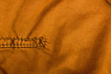 clothing items stonewashed cotton fabric texture with seams, clasps, buttons and rivets, macro