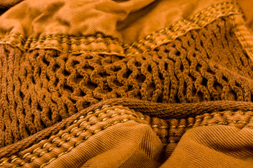 clothing items stonewashed cotton fabric texture with seams, clasps, buttons and rivets, macro