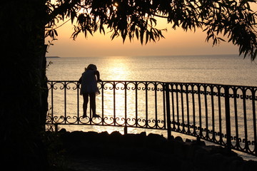 couple walking on beach at sunset