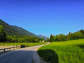 Fototapeta na wymiar Kranjska Gora, Slovenia - June 07, 2019: Road between mountains near Kransjka gora.