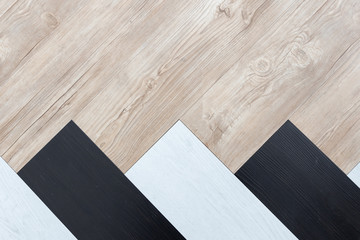 top view of black, white and brown wooden herringbone floor background texture.