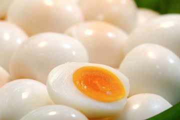 Close up a pile of boiled eggs in a basket  with blurred a green banana leave