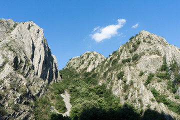 Big rocks in a valley. Sunny day with green trees in the cliff. Mountains in a National Natural...