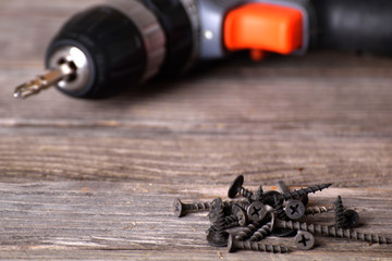 Close up Electric drill on wooden table background and copy space.  Hammer drill or screwdriver,...
