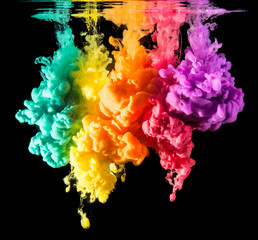 Colorful paint drops from above mixing in water. Ink swirling underwater