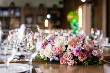 Wine glasses in the foreground. Wedding Banquet or gala dinner. The chairs and table for guests, served with cutlery and crockery.