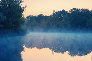 quiet river in a mist at the early morning
