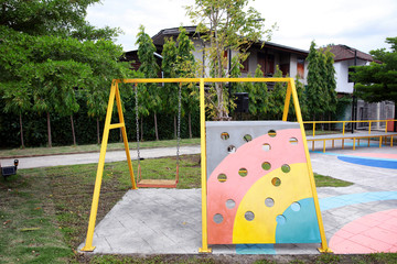 Handmade swing and slider at public playground