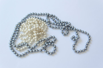 White and black pearl elegant necklace on white background