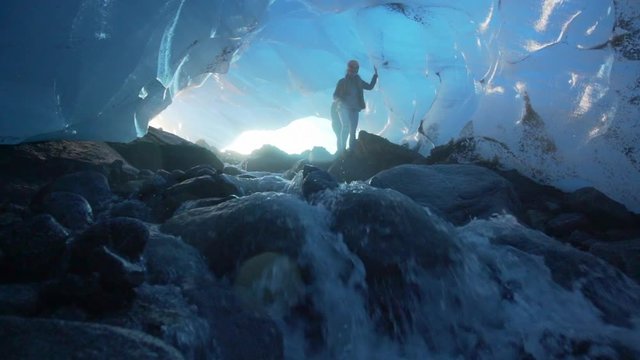 Slow Motion: Happy Young Women on Huge Rocks in Amazing Ice Cave, Mendenhall Glacier, Alaska