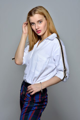 beautiful blonde woman in white shirt and checked trousers