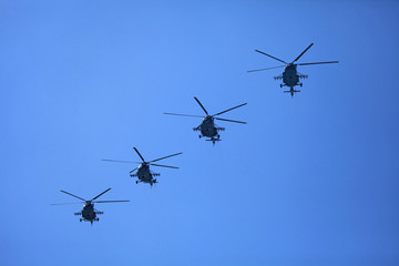 Fototapeta na wymiar Kyiv, Ukraine - August 24, 2018: Helicopters (military multipurpose Mi-8) in the sky during the military technique parade in Kiev. Independence day celebration. Military equipment of the armed forces 