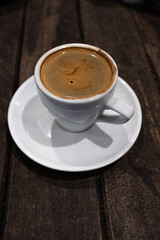 double espresson in a white cup against a dark background