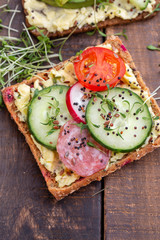 Sandwiches with cream cheese, vegetables and salami.