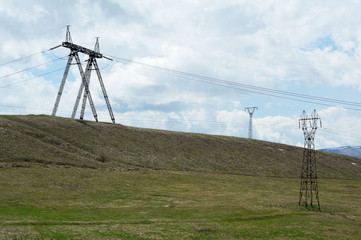 Fototapeta na wymiar Overhead line supports in hilled country