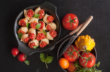 Stuffed large shells pasta with meat and tomatoes in sauce. Conchiglioni. Italian cuisine. Copy space.