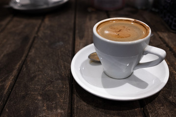 double espresson in a white cup against a dark background