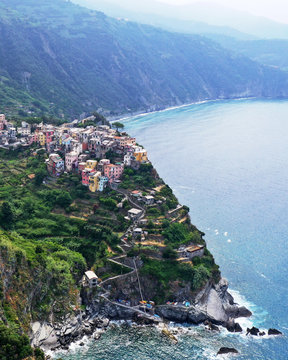 Aerial view of Corniglia village on rocky coast, Cinque Terre, Italy.