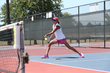 A mixed doubles team competes in a pickleball tournament