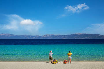 Two kayak enthusiasts getting ready to go kayaking on the turquoise waters of Lake Tahoe