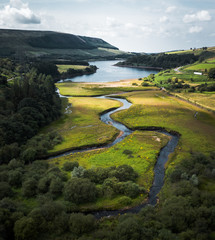 Stunning Peak District National Park Aerial shot at the Woodhead to Torside reservoirs showing the streams of water connecting the two